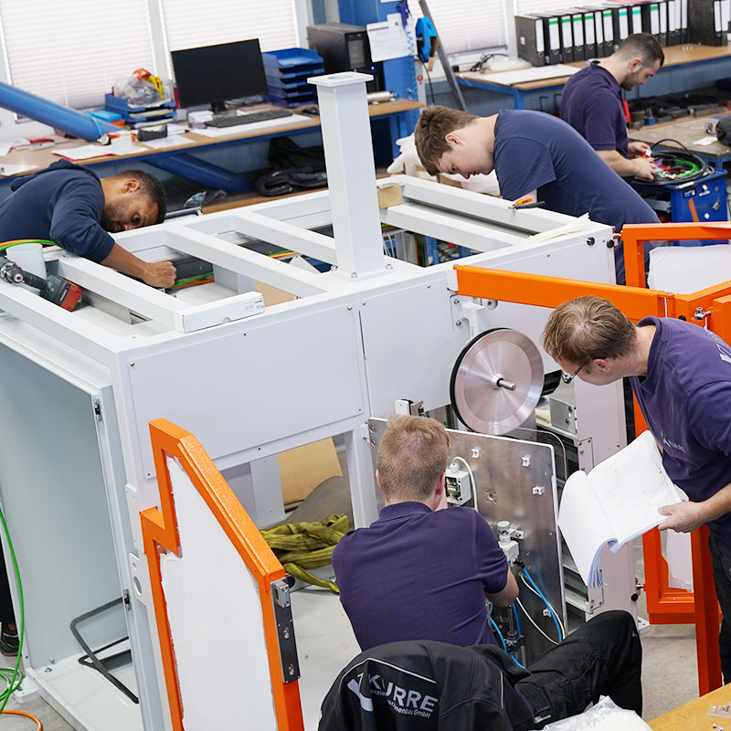 KURRE trainees assemble a machine in the assembly hall